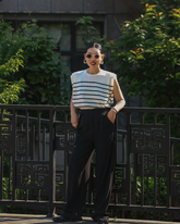 a lady wears a striped knitted tank top with black pants